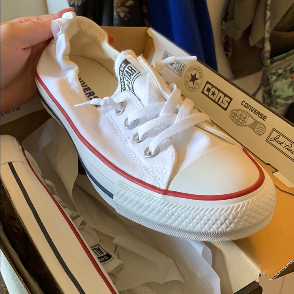 Never before worn white slip-on Converse.